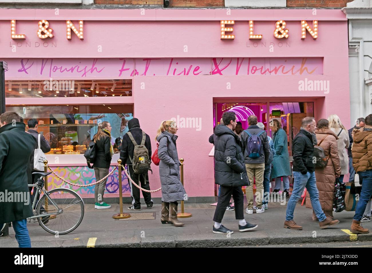 Menschen Fußgänger, die außerhalb VON EL&N gehen Essen, Leben und nähren rosa Café in Wardour Street Soho London England Großbritannien KATHY DEWITT Stockfoto