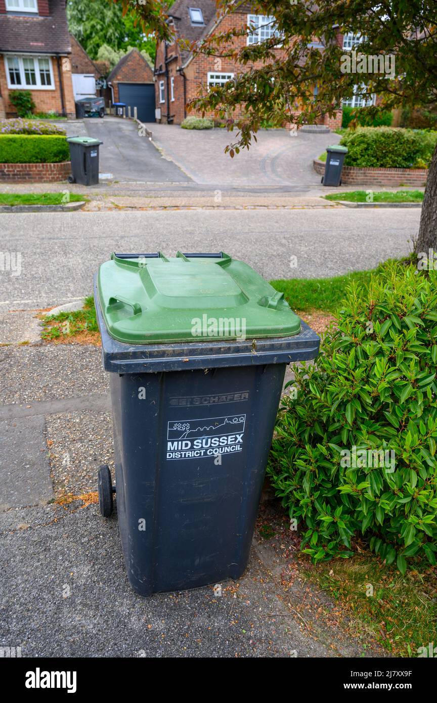 Grüne Behälter in Wohnstraße bereit zur Abholung. Stockfoto