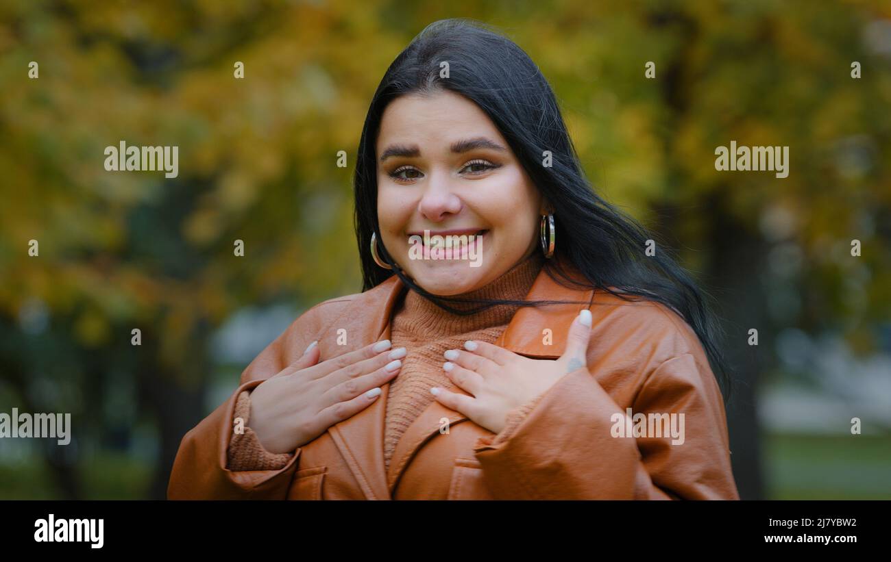 Porträt erstaunt hispanischen glückliches Mädchen erhält unerwartete Überraschung im Park im Freien junge enthusiastische Frau freut sich, die Hände auf Brust weiblich Stockfoto