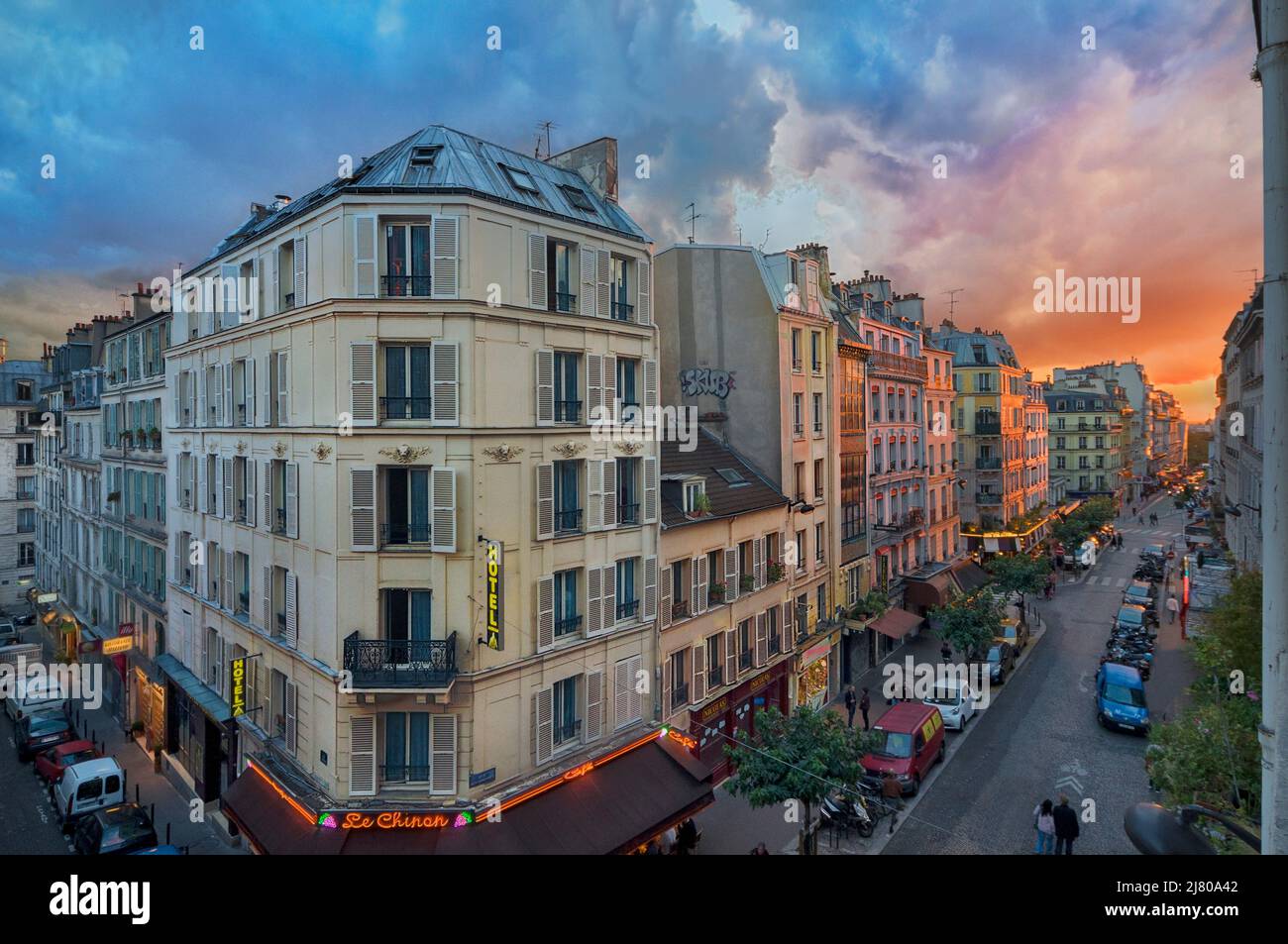 Der Sonnenuntergang über der Rue Audran und der Rue des Abbesses mit Blick nach Westen und auf den Friedhof von Montmartre. Im Vordergrund links befindet sich l’Hôtel Stockfoto
