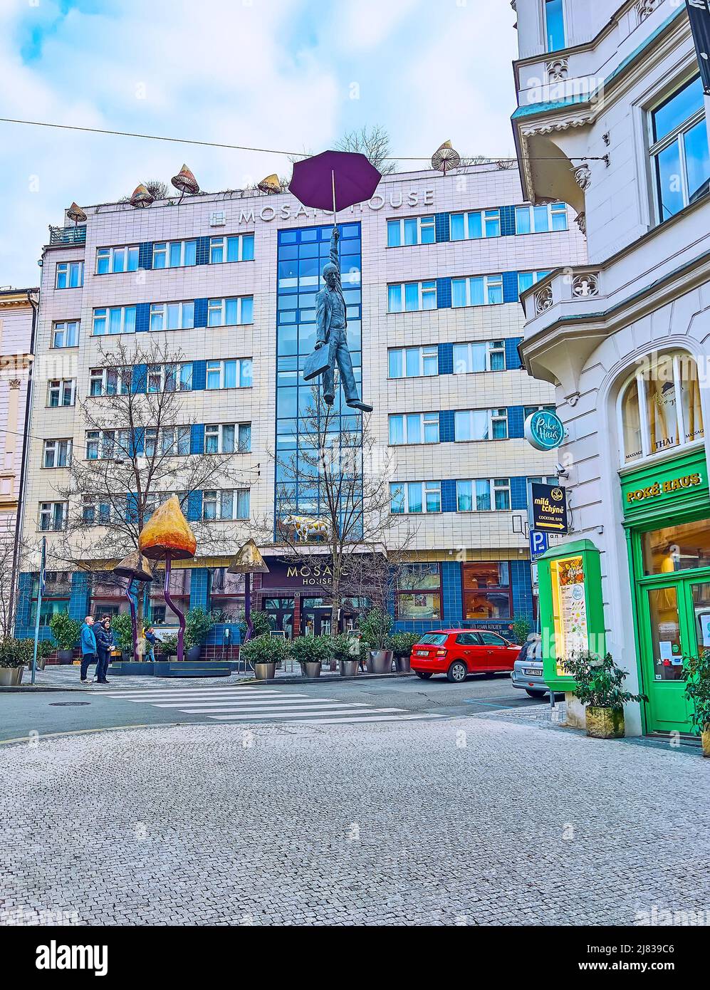PRAG, TSCHECHISCHE REPUBLIK - 5. MÄRZ 2022: Die Skulptur des hängenden Regenschirmmenschen oder eine leichte Unsicherheit vor dem Mosaic House Design Hotel, Odboru Stre Stockfoto
