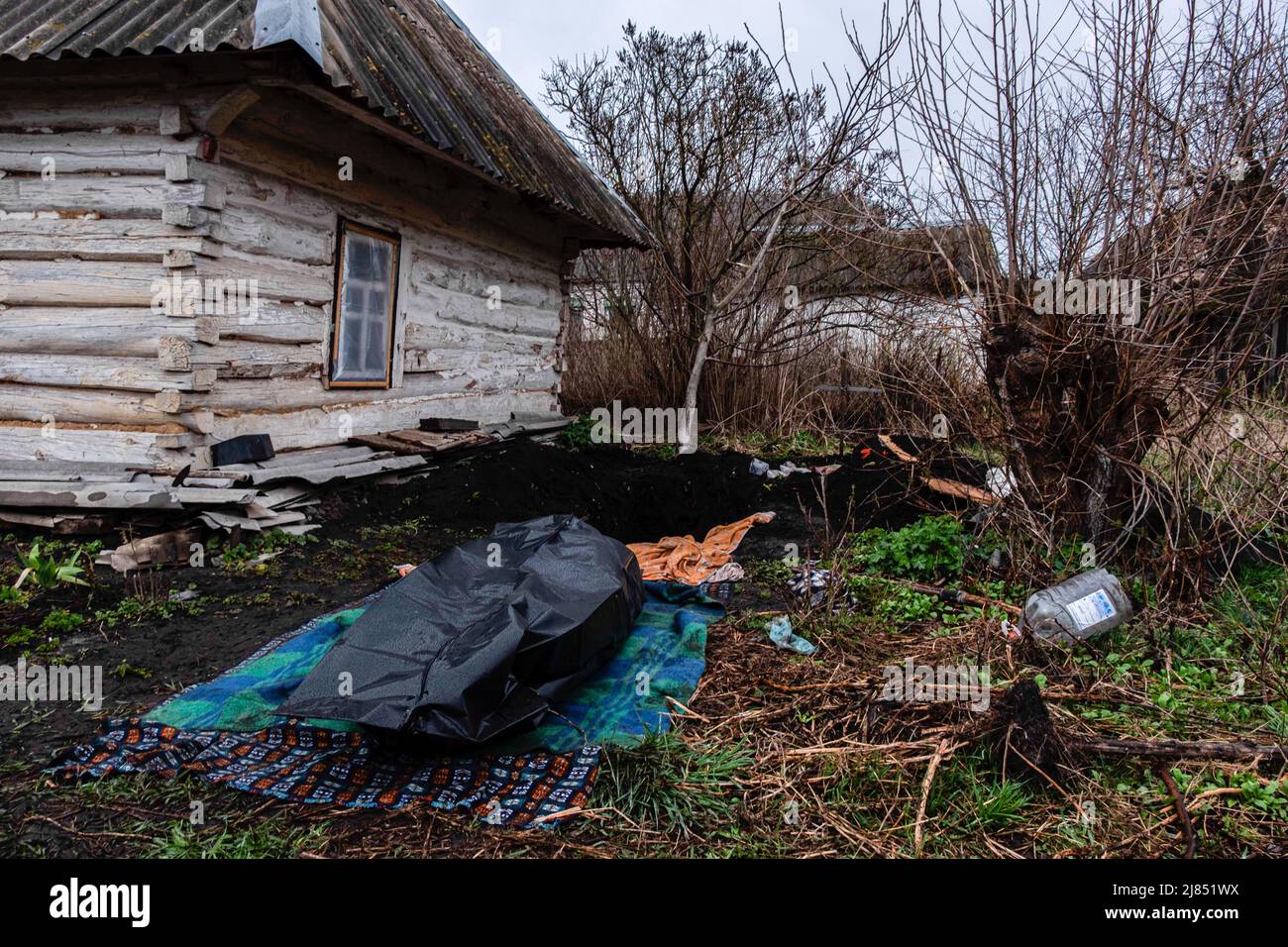 Ein Mann, der während der russischen Besatzung durch natürliche Ursachen getötet wurde, wurde im Garten seines Hauses begraben und nun unbegraben, um von der Polizei zur Untersuchung abgeholt zu werden. Lipovka ist eine kleine Stadt in der Bucha-Region, 60 km westlich von der Hauptstadt. Ein Gebiet mit vielen kleinen Dörfern, das seit mehr als einem Monat ohne Licht, Wasser, Gas, Wärme und Kommunikation ist. Lipovka war zu 40 % erschüttern, es wurden Massenmorde von Zivilisten durch die russischen Besatzer registriert, die Infrastruktur zerstört, Gebiete abgebaut. Stockfoto