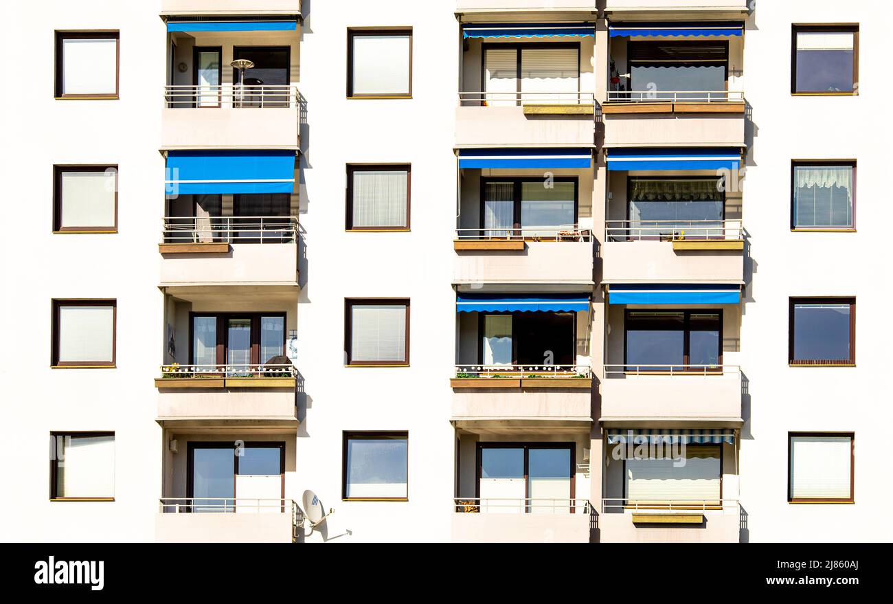 Traditionelle Gebäudefassade mit Fenstern, Jalousie, Balkonen in Österreich, Immobilienkonzept Stockfoto