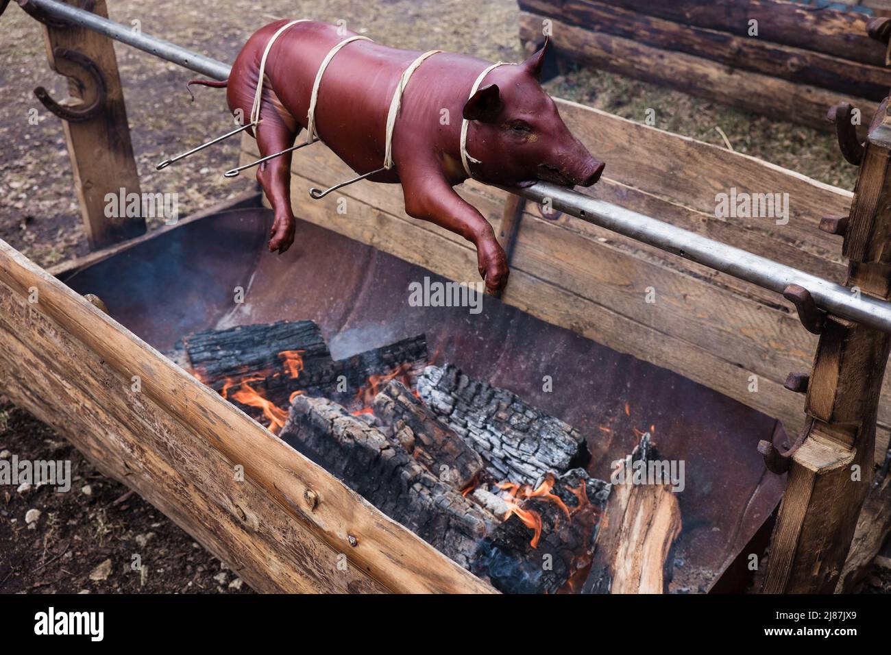 Ferkel auf dem Grill, Schweinebraten. Kochen ein ganzes kleines Schwein auf Feuer Stockfoto