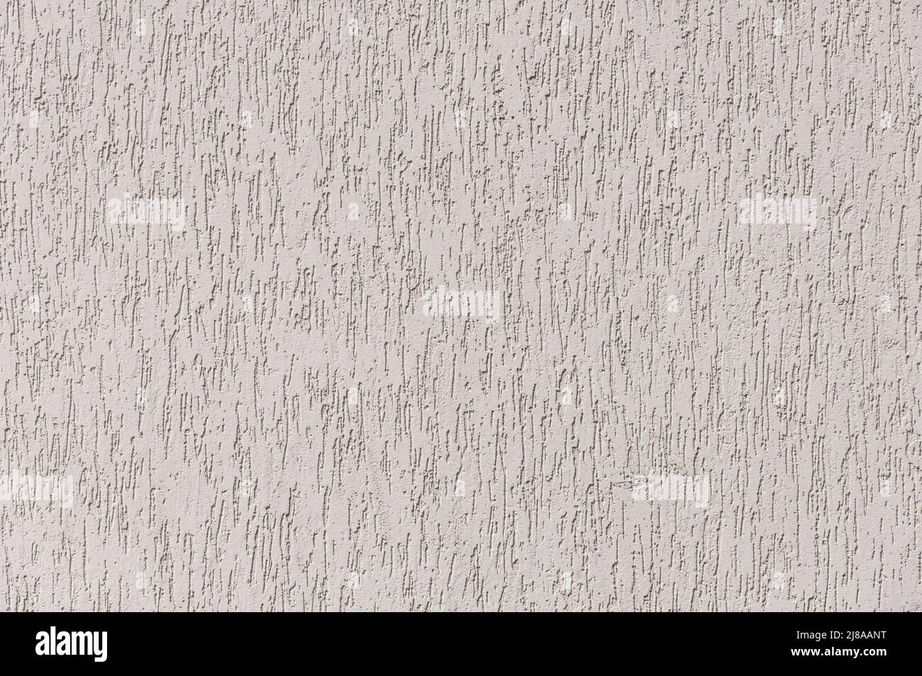 Textur von beigefarbenem Putz Gebäude Beschichtung Hintergrund. Willkürliches Muster. Stockfoto
