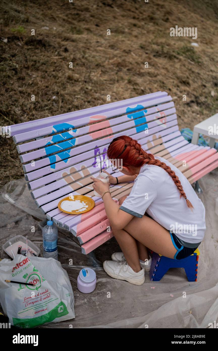 Die junge Illustratorin Carla Loza aus der Region malt während der städtischen Künstlerinitiative „Bancos de Color“, Z, eine Holzbank im beliebten Jose Antonio Laborteta Park Stockfoto