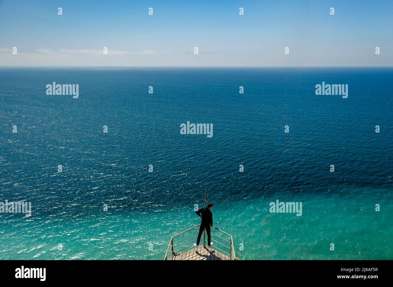 Eine Aussichtsplattform auf einem Felsen mit Stufen, die das Schwarze Meer in Form eines Schiffshecks überblicken. Eine Aussichtsplattform aus Holz, mit einer Bank und einem Stockfoto