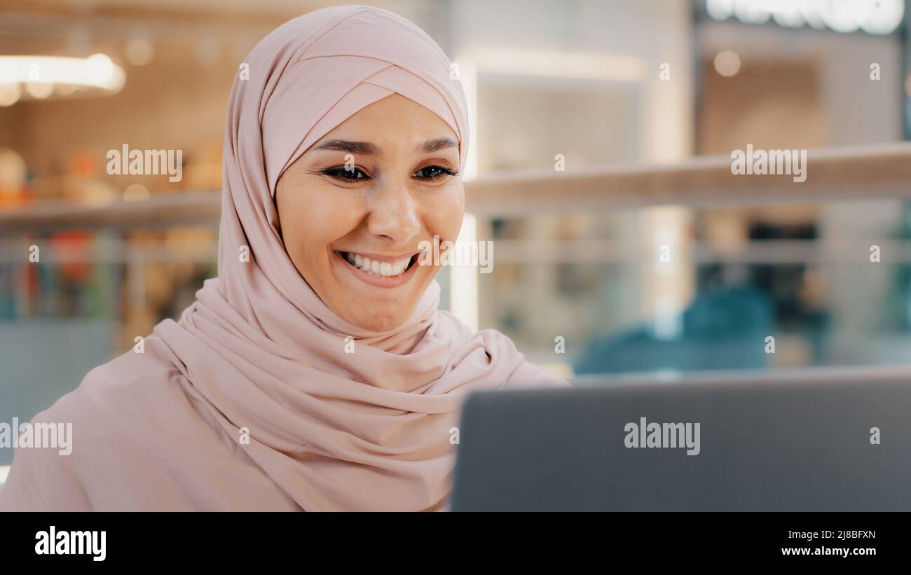 Junge arabische Geschäftsfrau mit Videokonferenz mit Laptop am Schreibtisch Mädchen Manager kommuniziert berät Client über Web-Chat muslimische weiblich Stockfoto