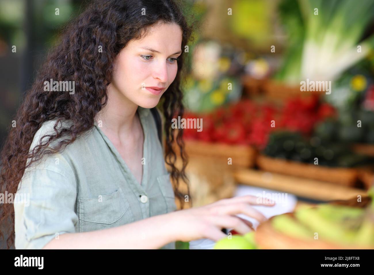 Zufriedener Kunde bereit, Gemüse in einer Greengrocery zu fangen Stockfoto
