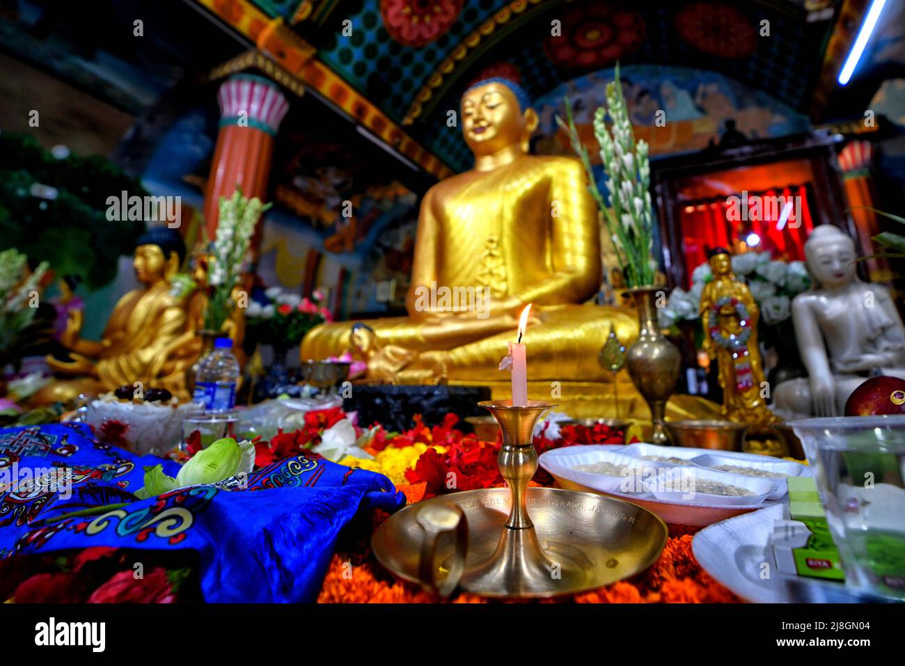 Kalkutta, Indien. 16.. Mai 2022. Eine brennende Kerze, die vor einer Statue von Lord Buddha in 