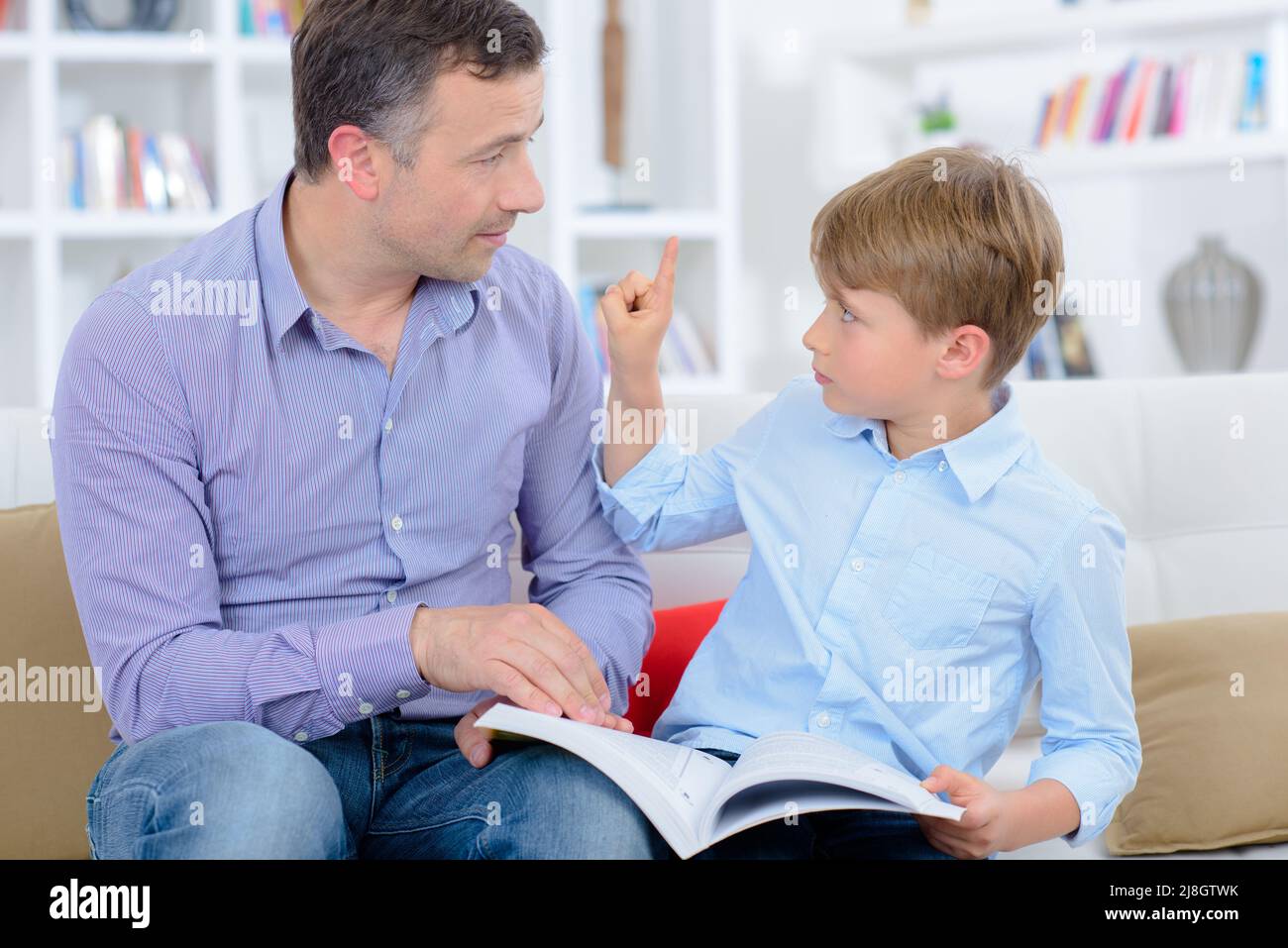 Vater und sein Sohn lesen ein Buch Stockfoto