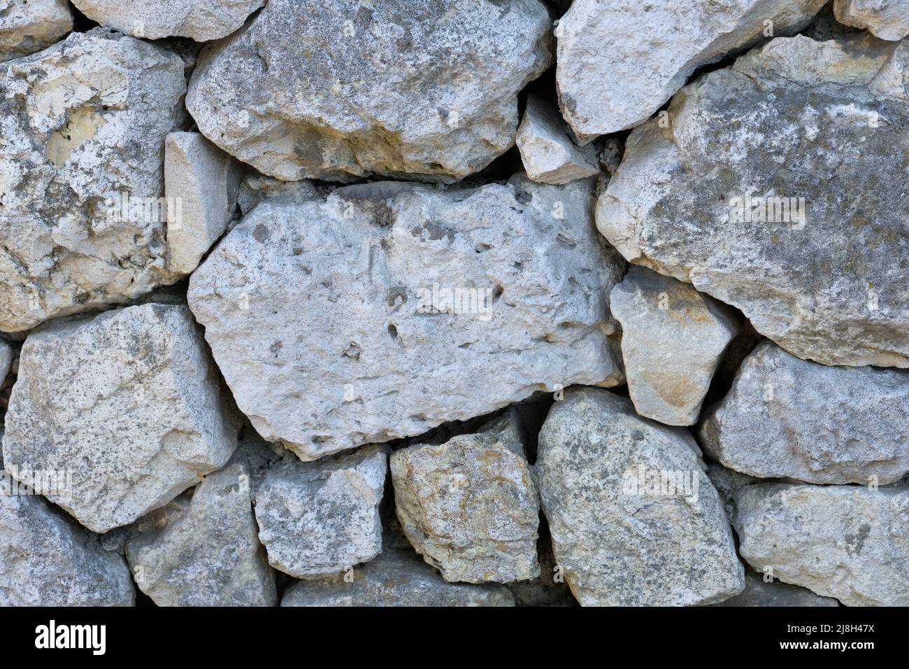 Hintergrund der Kalksteinwand mit felsiger Struktur Stockfoto