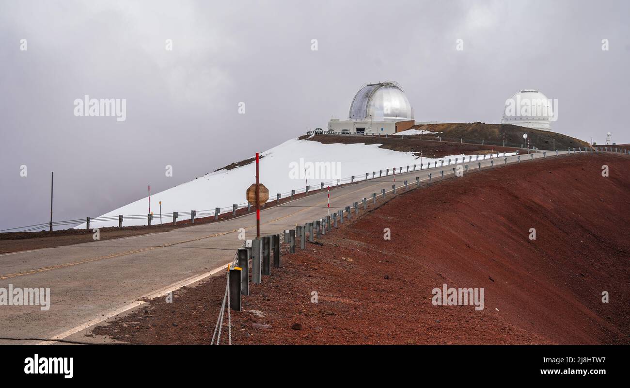 Unbefestigte Straße auf dem Gipfel des Mauna Kea Vulkans auf der Big Island von Hawaii führt zu mehreren internationalen Observatorien für astronomische Forschung Stockfoto