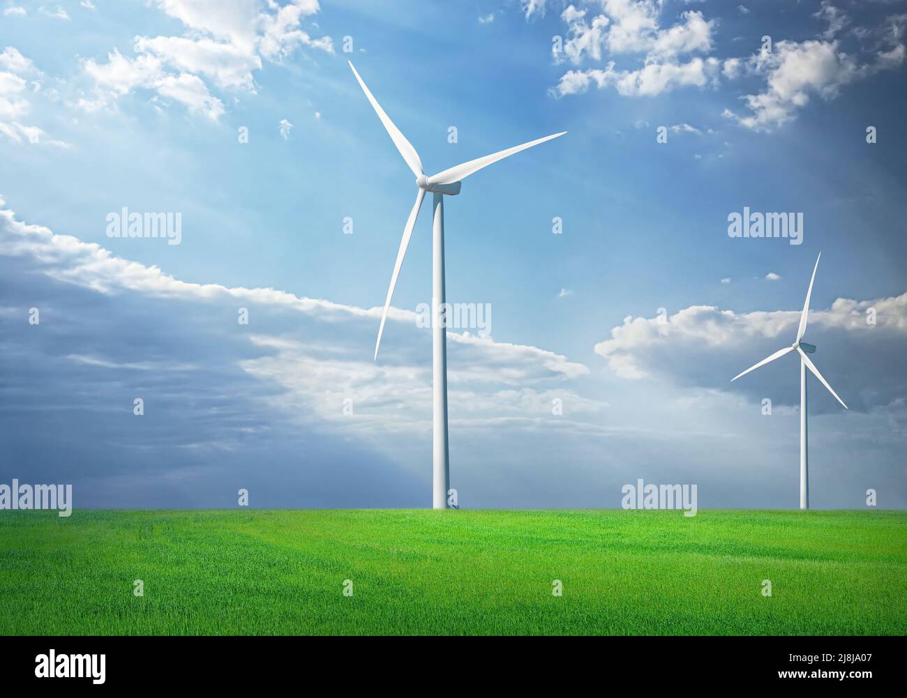 Windturbine in grüner Graslandschaft mit blauem Himmel mit Wolken und Sonnenschein Stockfoto