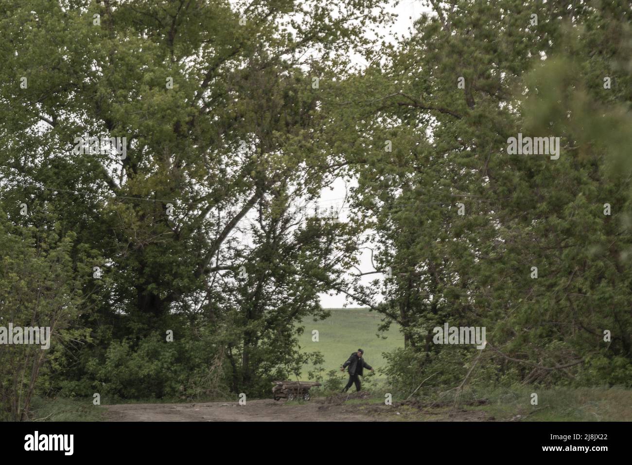Charkiw, Ukraine. 16.. Mai 2022. Ein Mann schleppt am Montag, den 16. Mai 2022, einen Feldweg östlich von Charkiw in Biskvitne, Ukraine, entlang. Ukrainische Streitkräfte sagten am Montag, dass ihre Gegenoffensive in der zweitgrößten Stadt Charkiw es ihnen ermöglicht hat, russische Streitkräfte in einem der größten Rückschläge für Moskau seit Beginn der Invasion zurückzudrängen. Foto von Ken Cedeno/UPI Credit: UPI/Alamy Live News Stockfoto