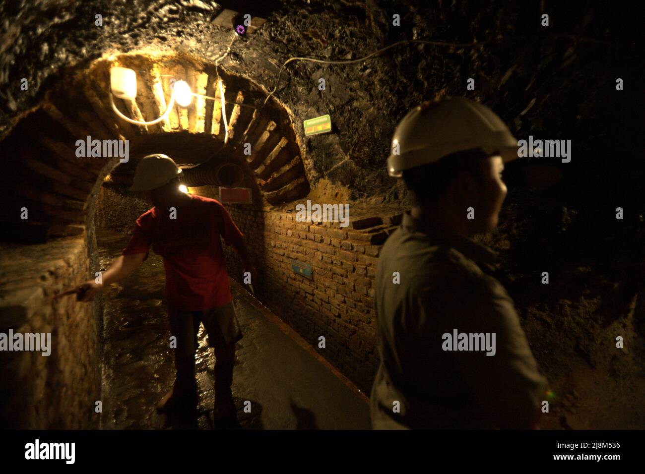 Besucher im unterirdischen Kohlebergbautunnel in Sawahlunto, einer ehemaligen Kohlebergbaustadt, die Ende des 19.. Jahrhunderts von niederländischen Kolonialisten in West-Sumatra, Indonesien, gegründet wurde. Stockfoto