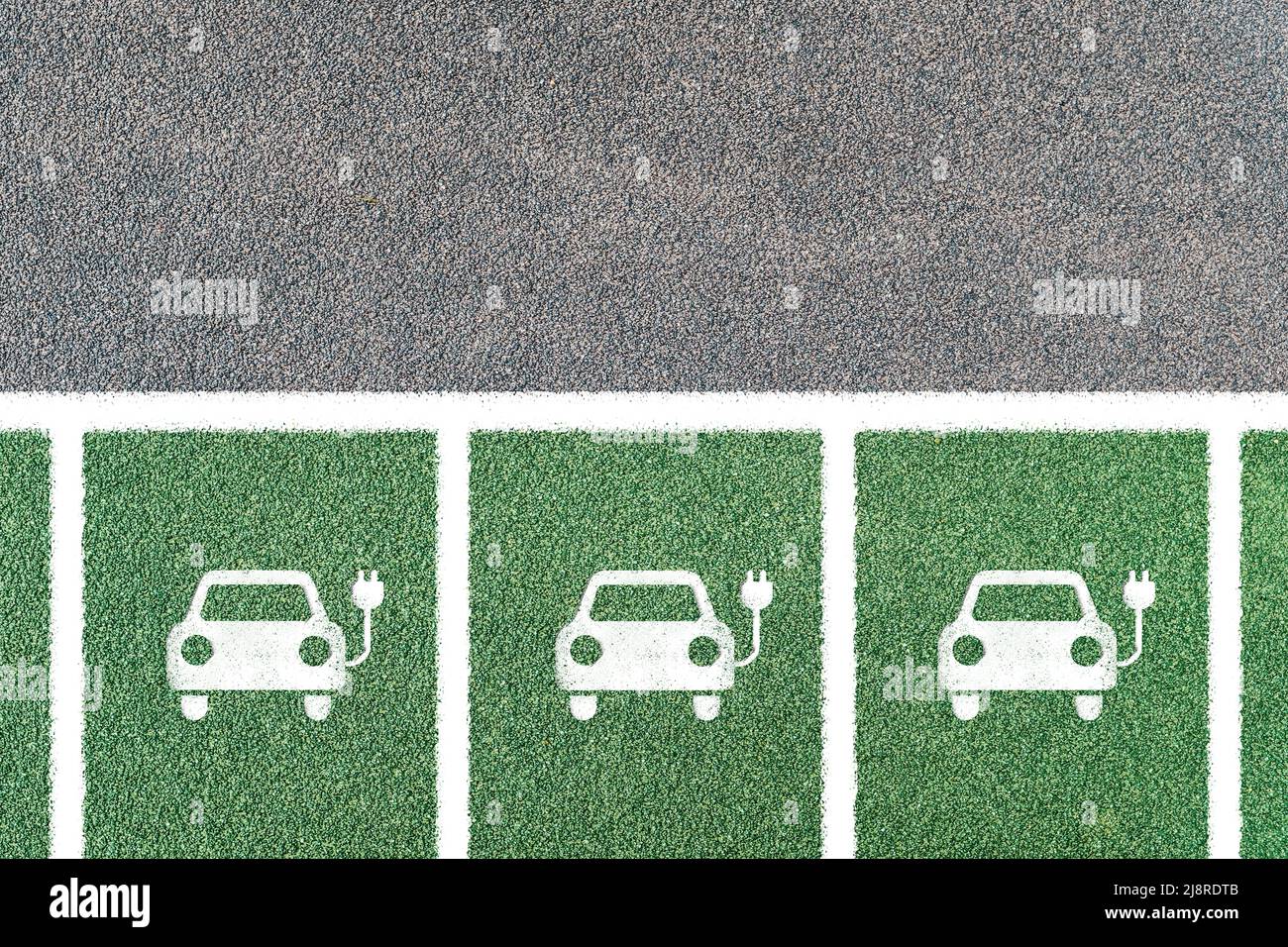 Parkplatz für Elektroautos nur mit Symbolen. Ladestation für Elektrofahrzeuge mit elektrischem Steckersymbol. Speicherplatz kopieren. Stockfoto