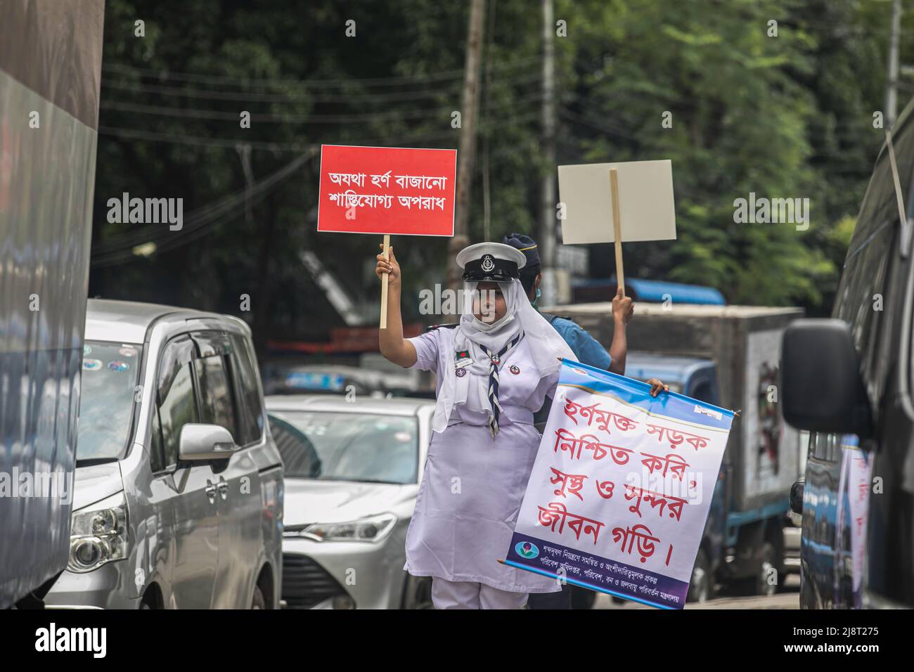 Ein Rover Scout-Mitglied hält während der No Horn-Kampagne in Dhaka ein Plakat und ein Banner im Verkehr. Lärmbelästigung ist in Bangladesch zu einem erheblichen Problem geworden. Das Umweltministerium für Umwelt, Wald und Klimawandel organisierte am 17.. Mai eine „No Horn“-Kampagne und ein mobiles Gericht, um die Lärmbelastung zu reduzieren. Die Kampagne läuft von 11 bis 4 Uhr an den Kreuzungen Gulshan-1, This Campaign & Mobile Court dient der Bewusstseinsentwicklung von Fahrern und Fahrzeugbesitzern. Damit sie die Mängel der Lärmbelästigung erkennen und das Hupen kontrollieren können. (Foto Stockfoto