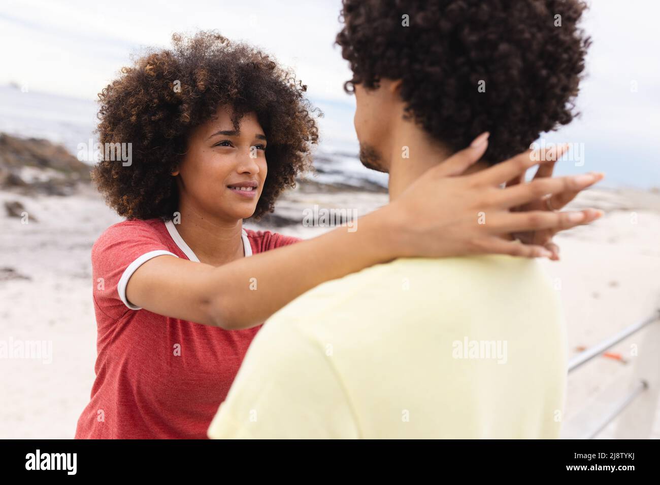 Liebevolle junge afroamerikanische Frau, die auf afro Freund schaut, während sie Freizeit zusammen verbringt Stockfoto
