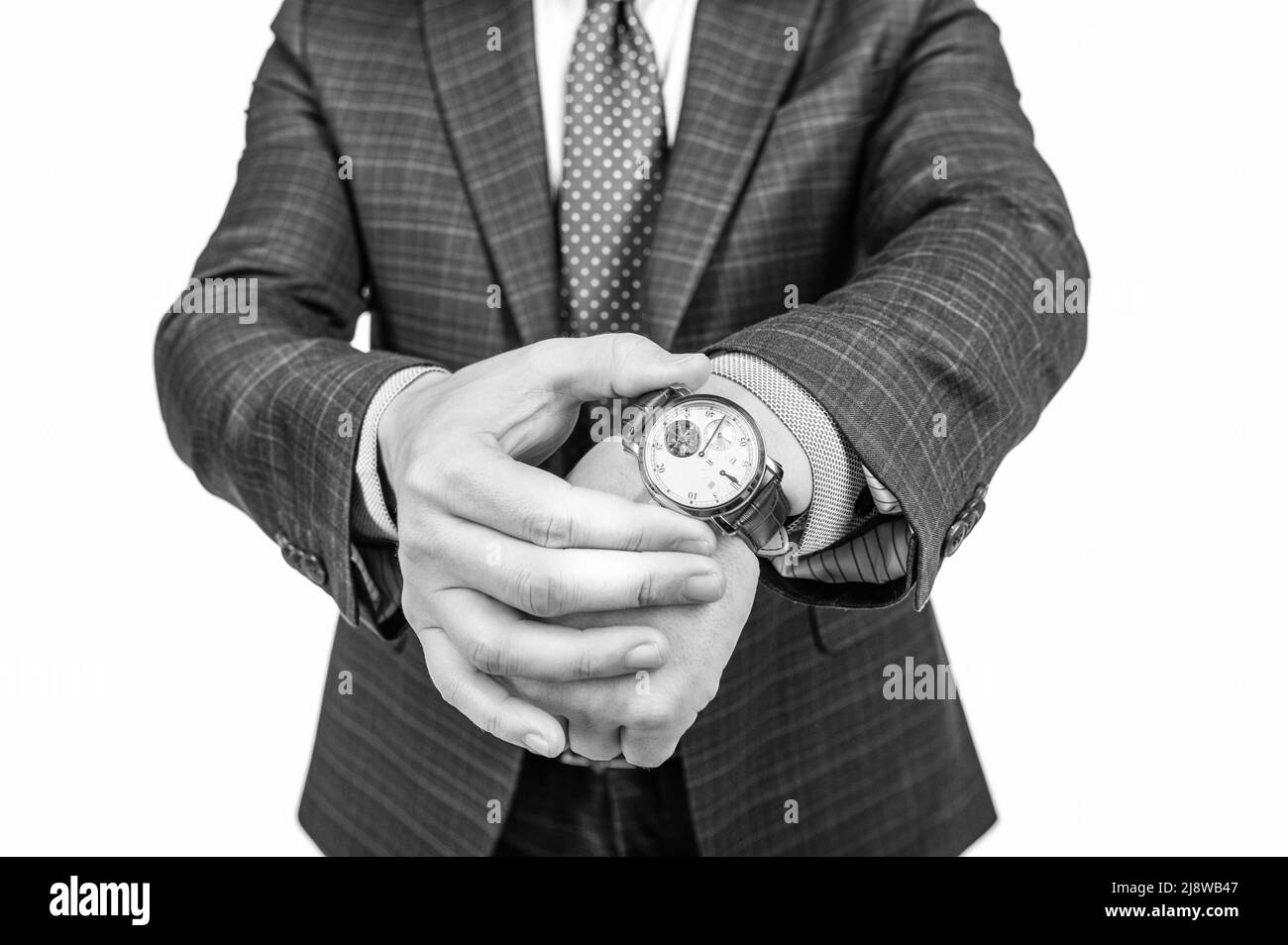 Ihre Uhr ist wichtig. Mann im Anzug, kurzer Blick, Kontrollzeit per Uhr. Zeitmanagement. Termin Stockfoto