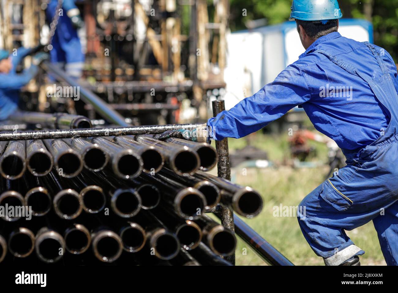 Mitarbeiter der Öl- und Gasindustrie betreibt Bohrrohre für Bohrinseln auf einer Bohrinsel. Stockfoto
