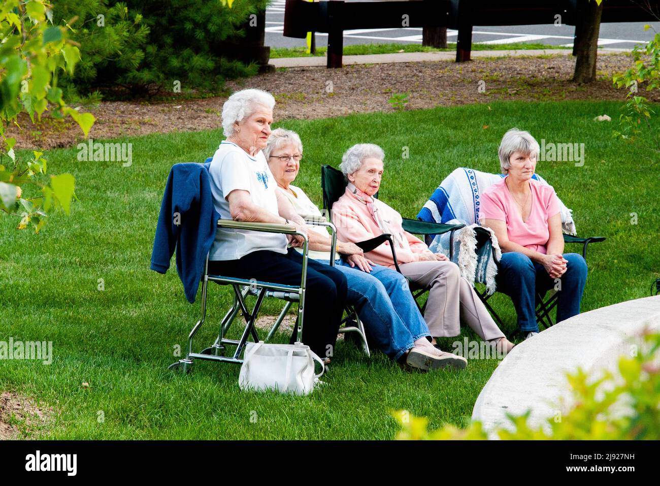 Gruppe älterer Frauen, die das Gemeinschaftskonzert beobachten Stockfoto