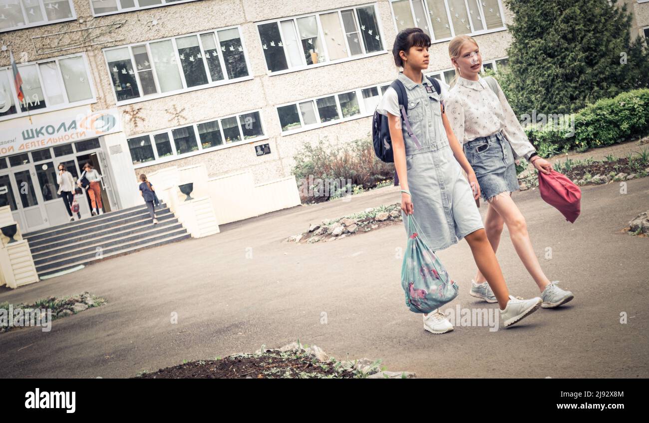 19.. Mai 2022, Russland Tomsk, zwei Schülerinnen gehen in der Nähe der Schule Editorial Stockfoto