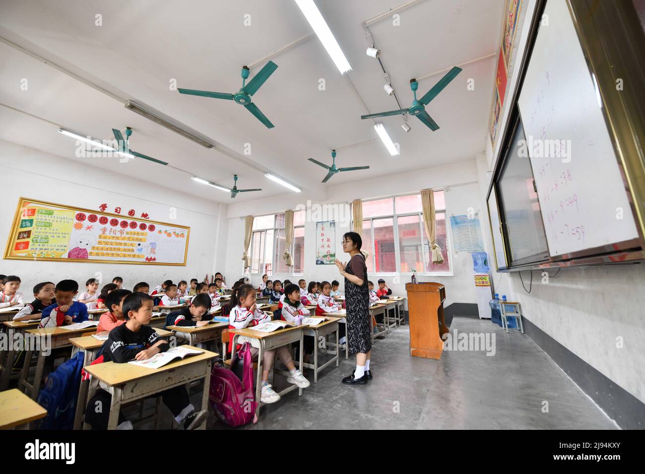 DU'AN, 20. Mai 2022 (Xinhua) -- Kinder besuchen eine Klasse in der Sanzhiyang Grundschule im Autonomen Bezirk Du'an Yao, südchinesische Autonome Region Guangxi Zhuang, 18. Mai 2022. Vor 11 Jahren wuchsen die Kinder von Sanzhiyang auf einer Diät aus gedämpftem Reis und Sojabohnen auf, einem der wenigen Dinge, die dort wachsen würden. Damals war Mangelernährung bei den Studenten üblich. Im Jahr 2011 begann ein Plan zur Verbesserung der Ernährung für Schüler in ländlichen Gebieten, der Schülern in Schulen wie Sanzhiyang nahrhafte Mahlzeiten bietet. Heute dient die gut ausgestattete Kantine der Grundschule von Sanzhiyang sorgenvoll Stockfoto