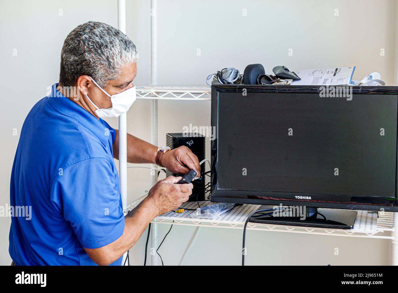 Miami Beach Florida, Kabel-tv-Installateure Reparatur-Techniker Installation arbeiten hispanischen Mann, männlich Stockfoto