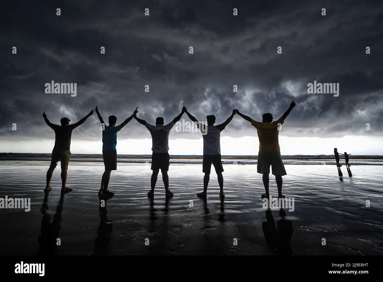 Menschen posieren für Fotos am Strand von Udaipur Beach, Digha (ca. 200 km von Kalkutta) mit einer dramatischen Wolkenlandschaft. Das India Meteorological Department (IMD) hat vorhergesagt, dass der Monsunregen aufgrund der Auswirkungen der zwei Zyklone Asani und Karim voraussichtlich eine Woche zu Beginn dieses Jahres eintreffen wird. (Foto von Avishek das / SOPA Images/Sipa USA) Stockfoto