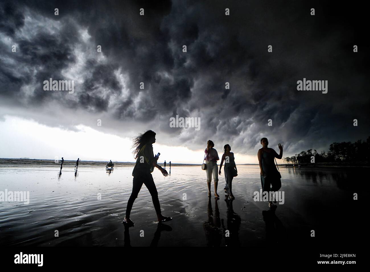 Die Menschen sahen, wie sie am Meer vor einem Wolkenbruch in Udaipur, Digha (ca. 200 km von Kalkutta entfernt) spazieren gingen. Das India Meteorological Department (IMD) hat vorhergesagt, dass der Monsunregen aufgrund der Auswirkungen der zwei Zyklone Asani und Karim voraussichtlich eine Woche zu Beginn dieses Jahres eintreffen wird. (Foto von Avishek das / SOPA Images/Sipa USA) Stockfoto
