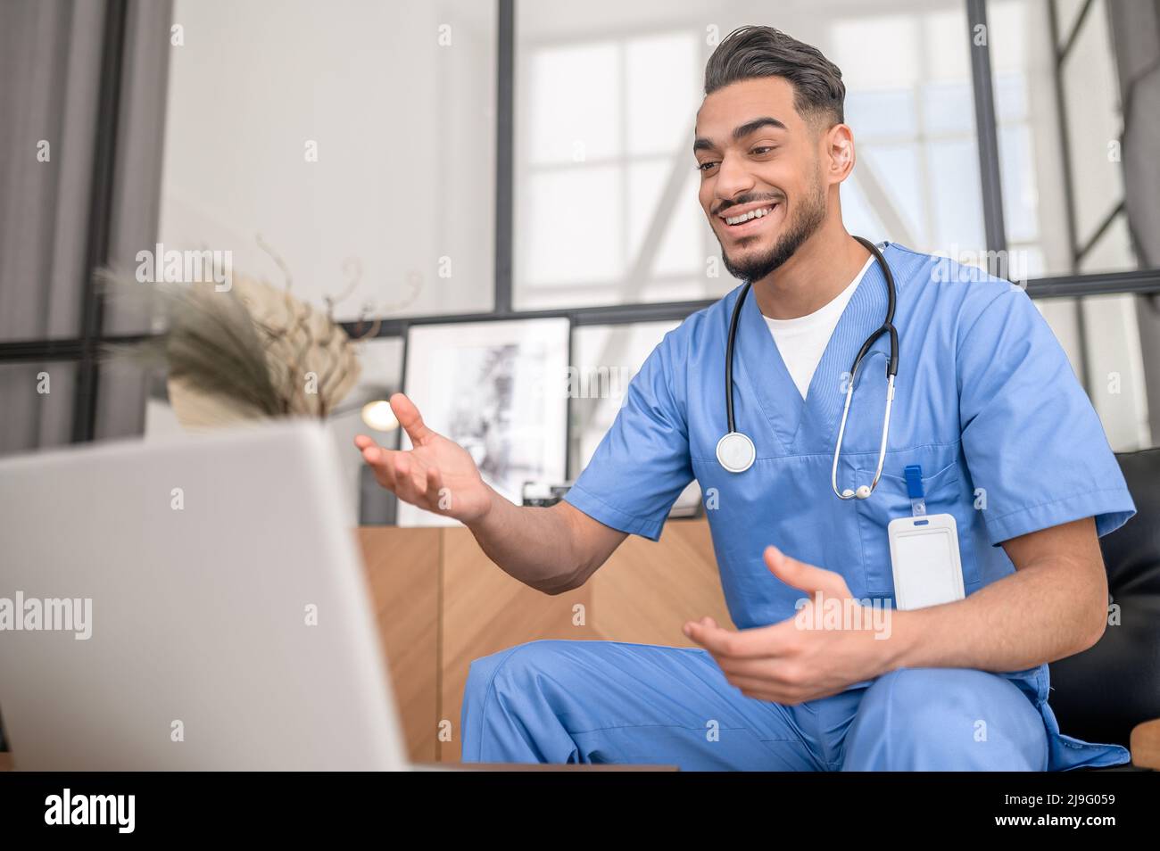 Mitarbeiter im Gesundheitswesen, der online mit seinem Patienten kommuniziert Stockfoto