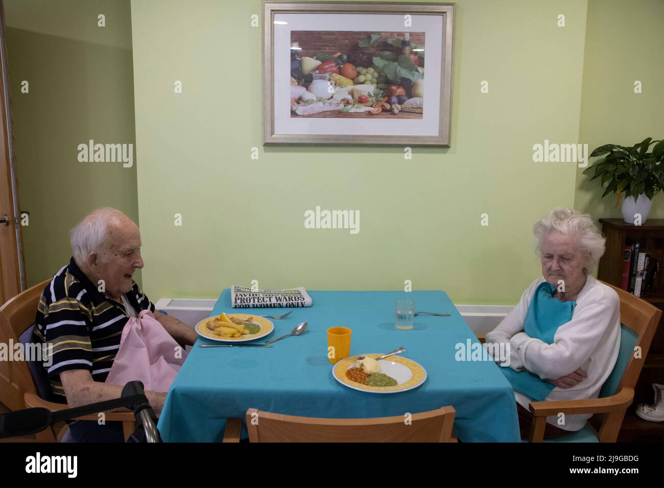 Ein älteres Paar saß an einem Esstisch in einem Pflegeheim in England, Großbritannien Stockfoto