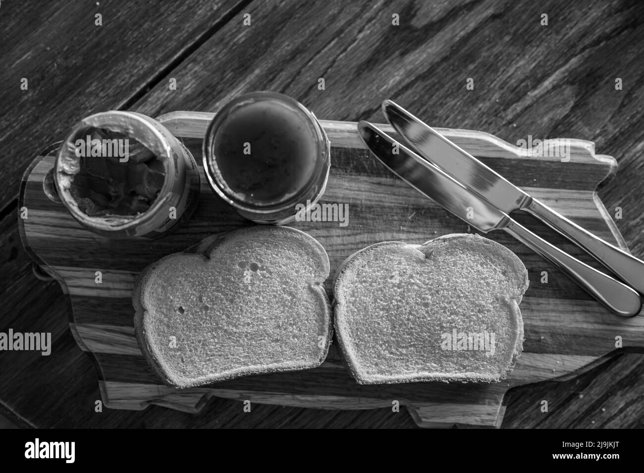 Selektiver Fokus auf Buttermesserkante, die zum Verbreiten einer Sonnenblumenbutter verwendet wird Stockfoto