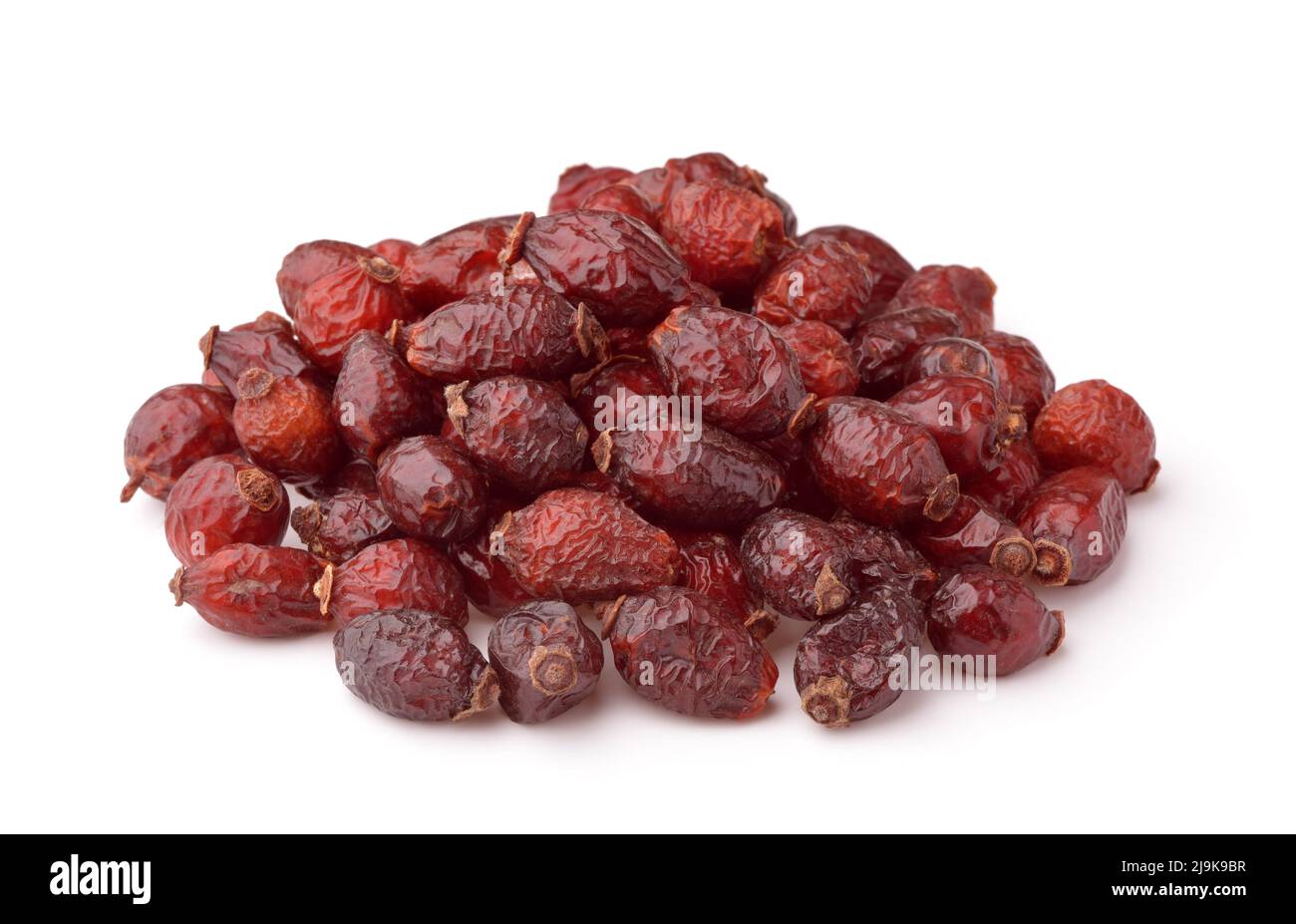 Haufen von getrockneten Hagebutten isoliert auf weiss Stockfoto