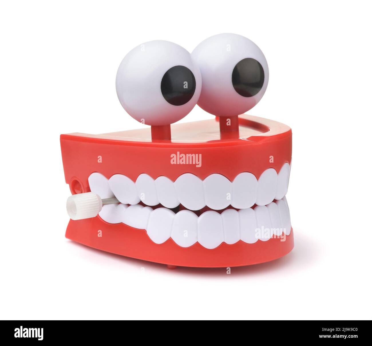 Lustige Spielzeug Uhrwerk springen Zähne mit Augen isoliert auf weiß Stockfoto
