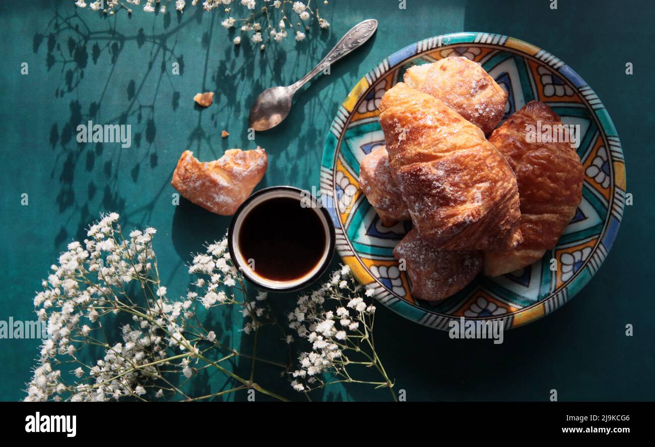 Süßer Morgen. Nahaufnahme von kleinen Croissants auf einem Teller. Stillleben. Stockfoto