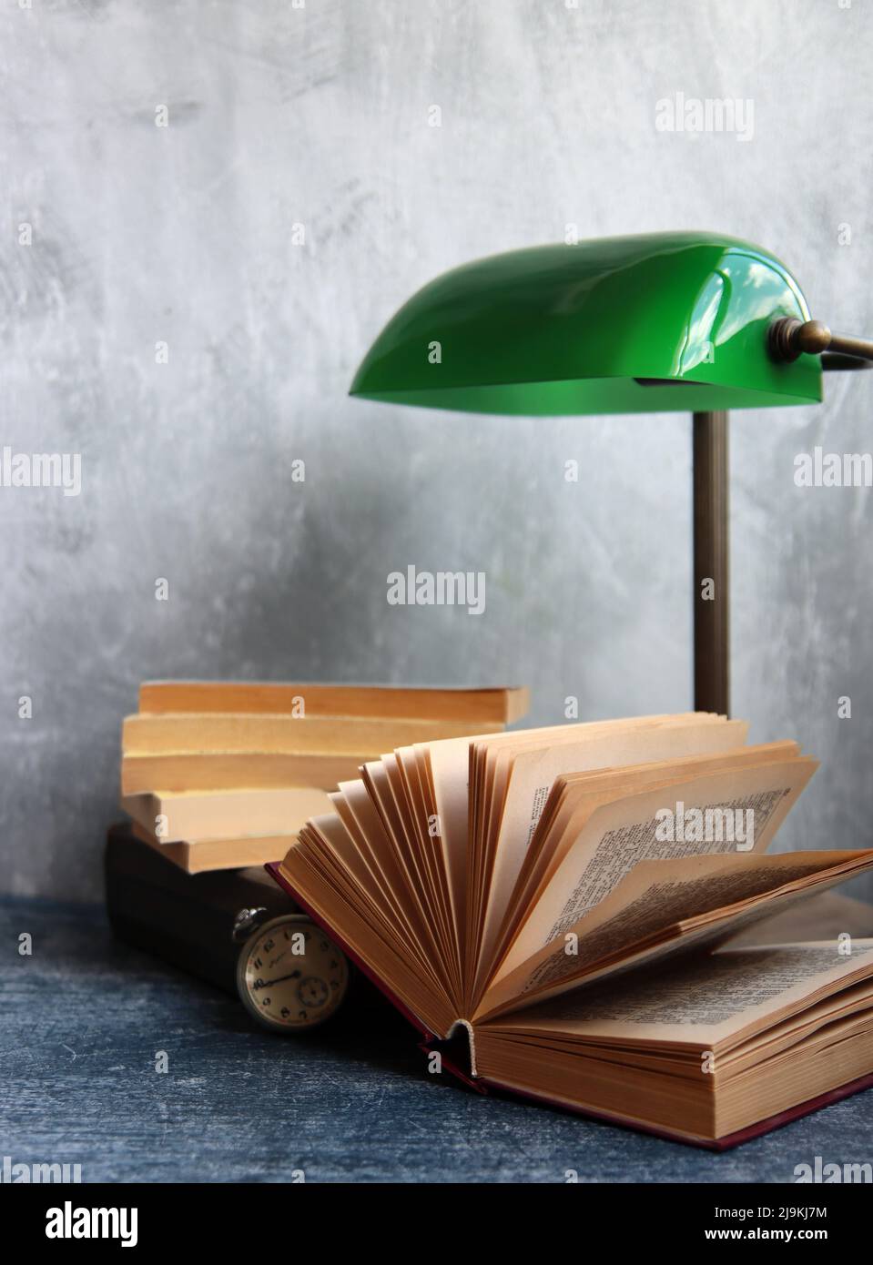 Einfache Komposition Stillleben mit Vintage-Lampe und Buch auf einem Schreibtisch. Retro-Stil Objekte Nahaufnahme Foto. Stockfoto