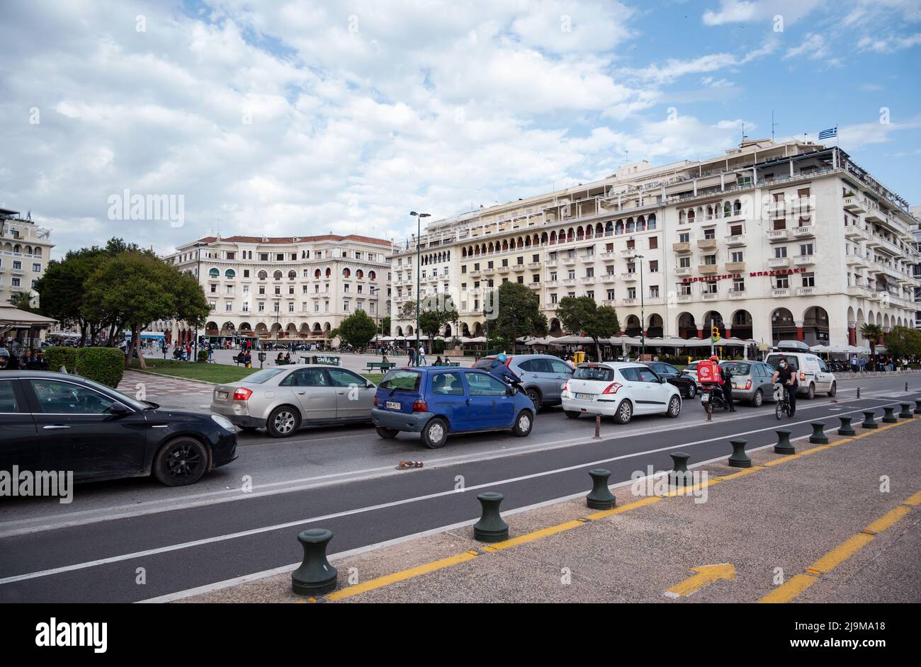 Blick auf den Aristoteles-Platz voller geschäftiger Touristen und Autos auf der Straße, die vom Strandspaziergang in Thessaloniki nach der Sperre aufgenommen wurden Stockfoto