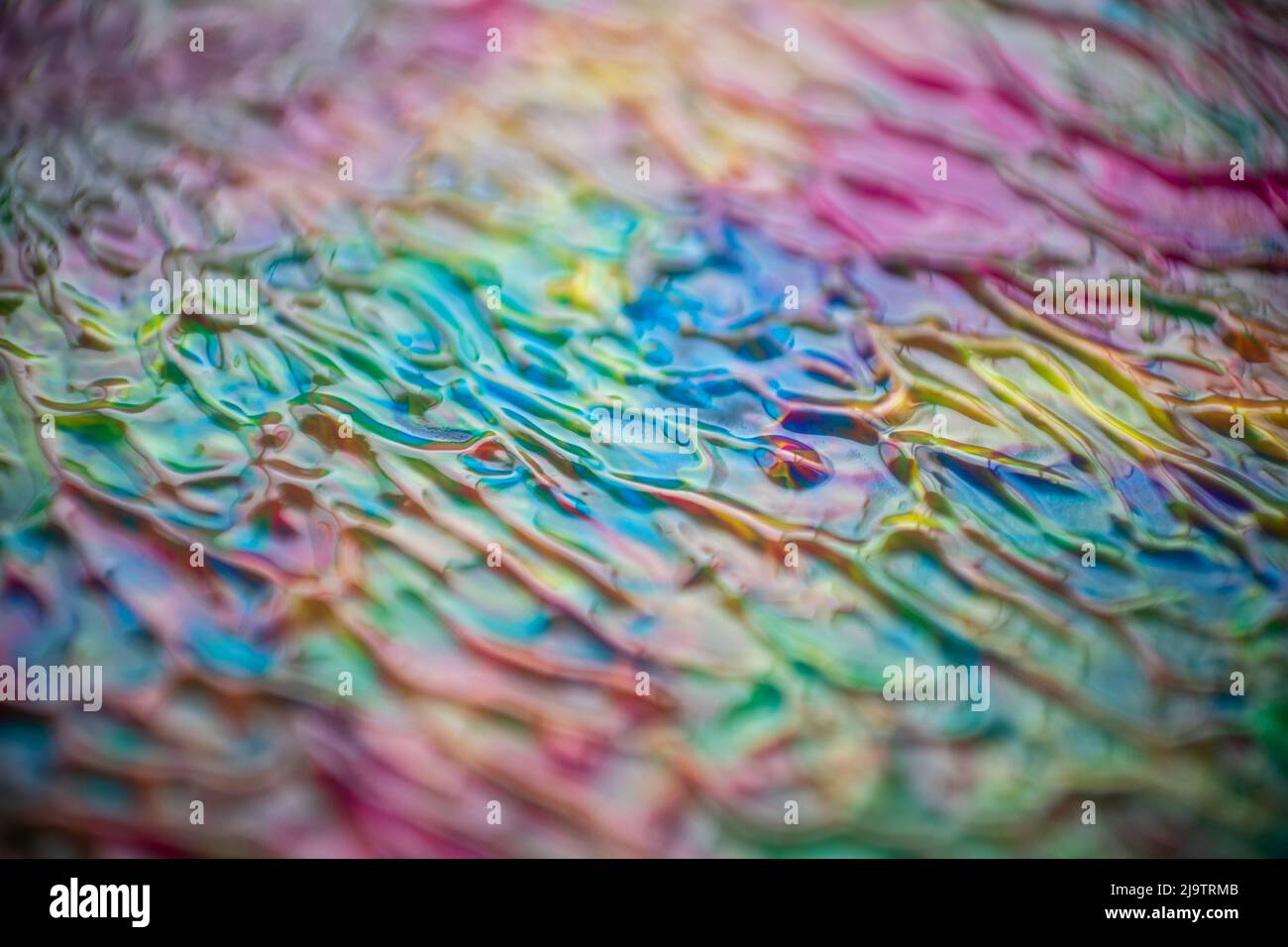 Textur aus Acryl in verschiedenen Farben, die geschwungene Linien in verschiedenen Richtungen bilden, ideal für Hintergründe und Texturen und für Grafikdesign Stockfoto