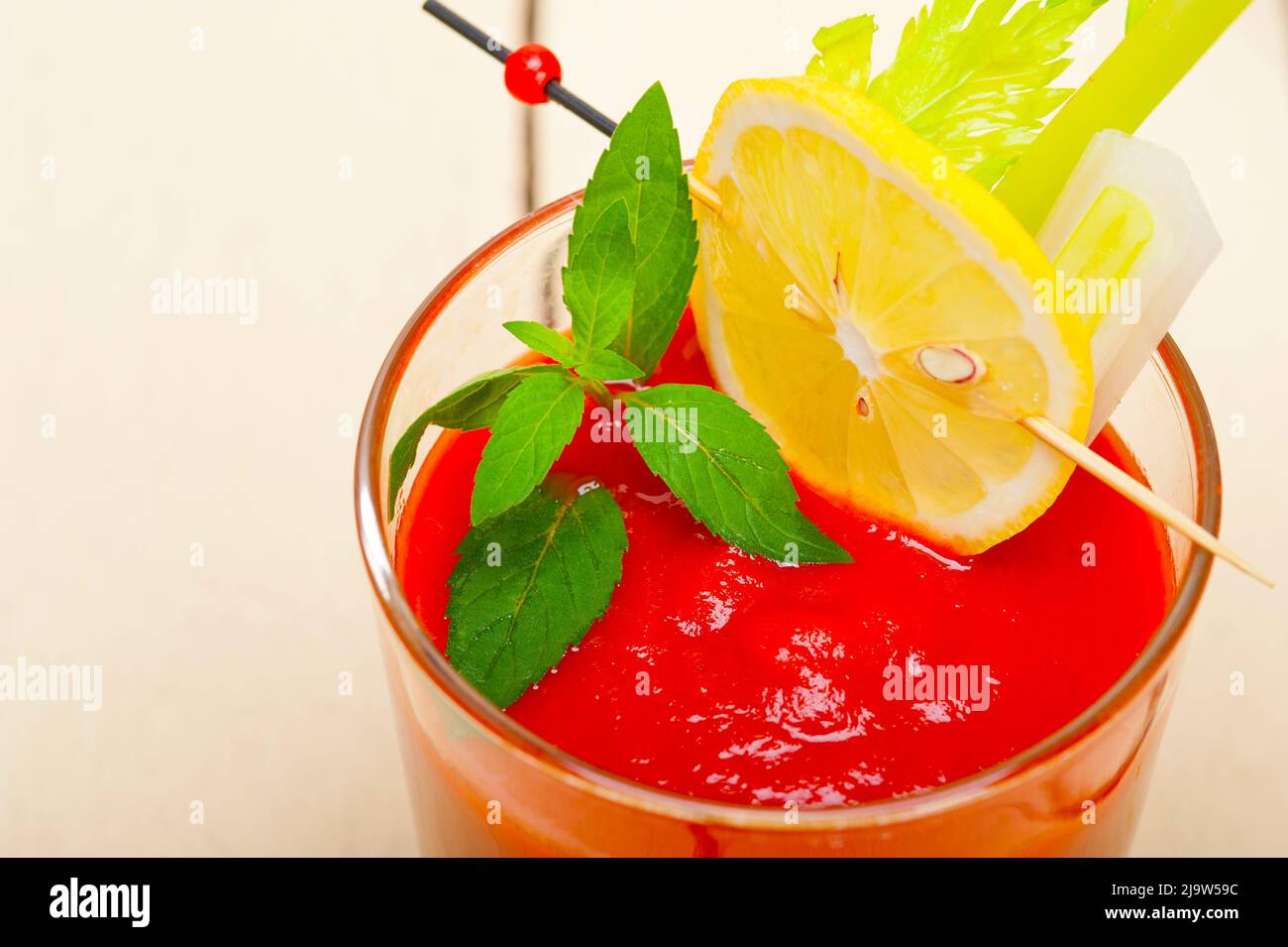frischer Saft Gazpacho Tomatensuppe auf ein Glas über weiße Holz Tisch Stockfoto