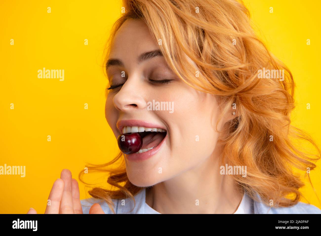 Womans genießen frische süße Kirsche. Weiblicher Mund, der süße Kirsche isst. Closeup weibliche Mund schmeckende süße Kirsche. Stockfoto