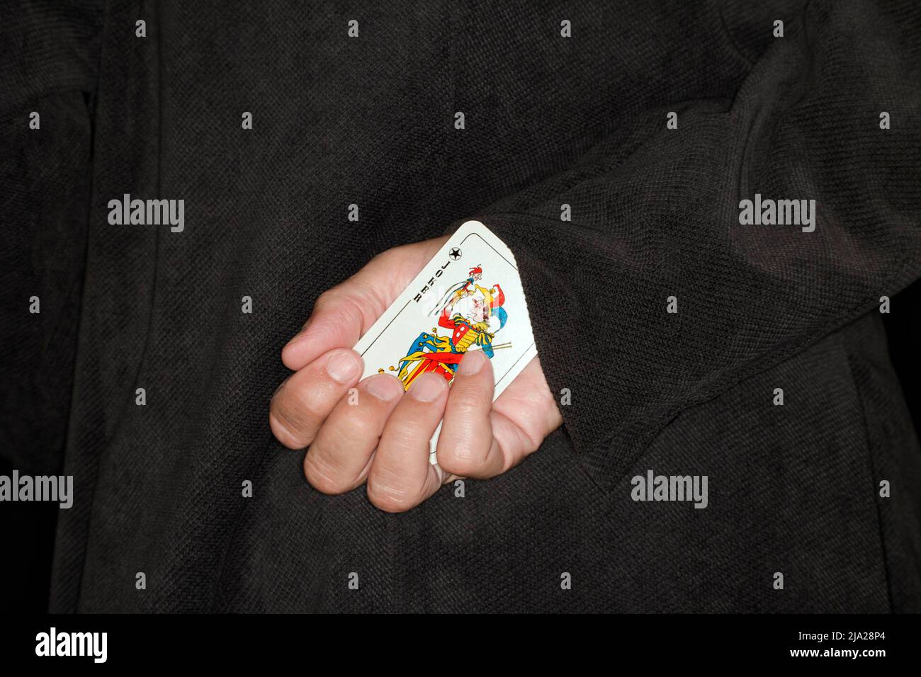 Spielkarte, Betrug, Symbol-Betrug, Symbol-Bild für einen weiteren Joker auf dem Ärmel Stockfoto