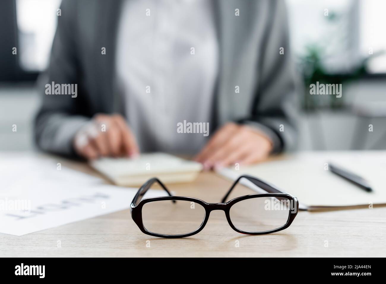 Selektiver Fokus der Brille in der Nähe des Finanzchefs im Büro Stockfoto