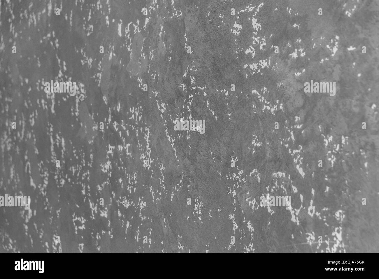 Graue Gipswand mit abstraktem Muster Stuckstruktur Hintergrundfläche. Stockfoto