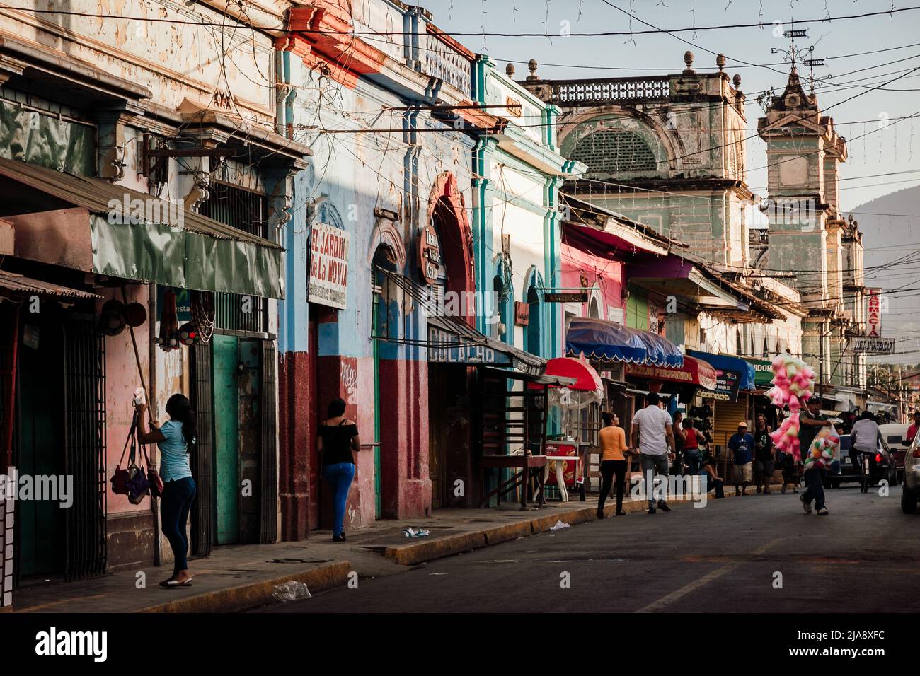 Goldene Stunde Straßenszene mit bunten Kolonialbauten und Kirchtürmen im heißen Granada, Nicaragua. Stockfoto