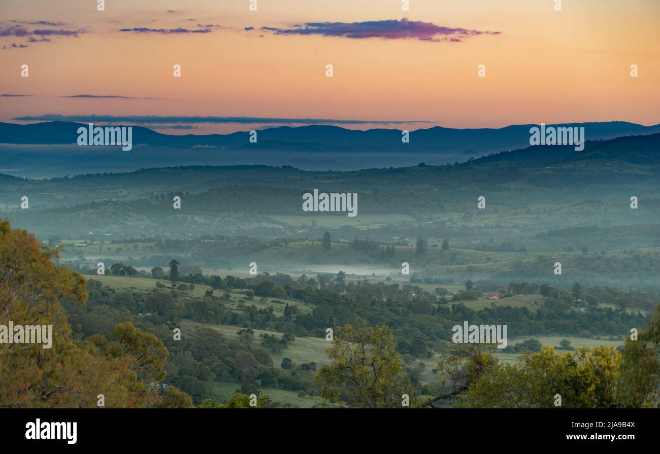 Bevor die Morgenröte über den Toowoomba Ranges, Queensland. Das frühe Licht strahlt ein ruhiges Leuchten aus und malte die Landschaft in sanften, vor Sonnenaufgang anmutenden Tönen Stockfoto