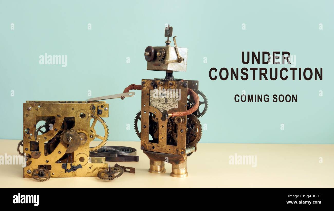 Der Roboter repariert den Mechanismus und die Inschrift im Bau kommt bald. Stockfoto