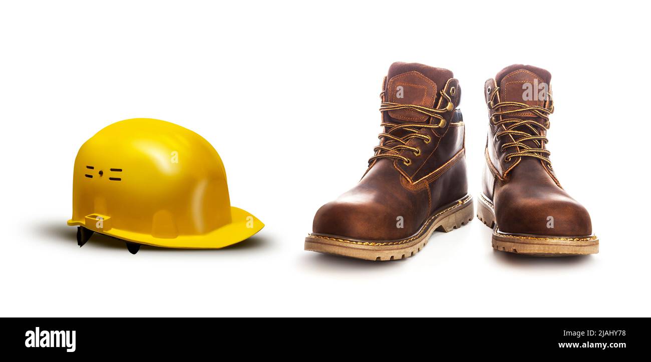 Sicherheitskonzept hart arbeiten. Arbeiter gelb Helm und Stiefel isoliert auf weißem Hintergrund, geschlossen Stockfoto