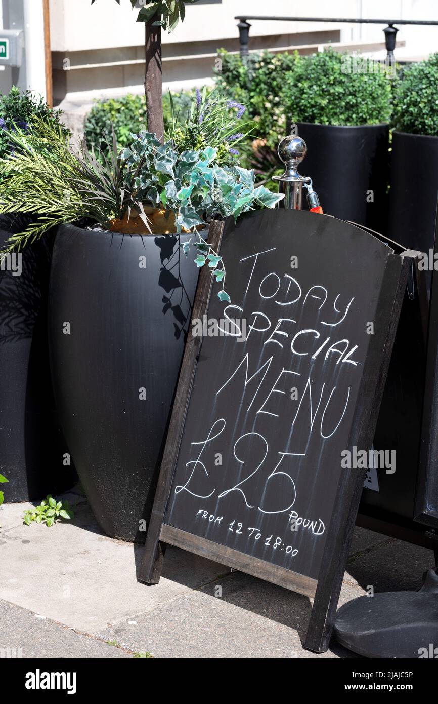 Eine Tafel mit einem Schild mit dem Today's Menu, das in Kreide darauf geschrieben ist. Die Schrift ist im Regen gelaufen. £25 Stockfoto